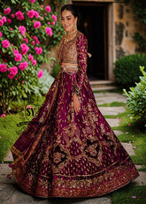 This striking two-tone Berry and Berry Burgundy lehenga choli is heavily embellished with shimmering gold handwork and harmonious silk threadwork for a modern classic look. The luxurious bodice is hand-embellished with diamante detailing, making you stand out in the crowd.
