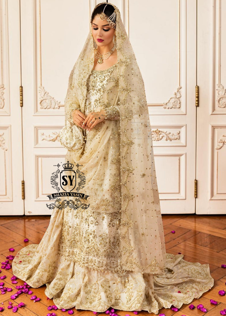Bride in a wedding dress with floral embellishments and long sheer sleeves, elegant and romantic gharara style.