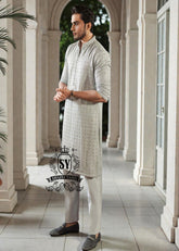 This exquisite kurta embodies sophisticated elegance and timeless grace. Crafted from the finest premium fabrics and meticulously designed with intricate embellishments and delicate sequin work, it exudes understated luxury.