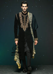 This jet black cocktail velvet form-fitting sherwani is the epitome of elegance. Its impeccable design and luxurious velvet fabric exude a touch of royalty.