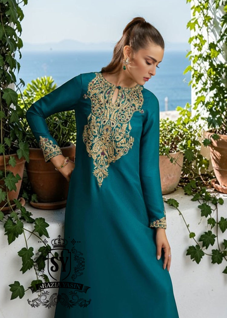 As wedding season blooms, make a sophisticated statement with our exquisite Teal Kaftan dress, crafted from pure raw silk and embellished with intricate dapka, naqshi, and cutdana embroidery. Every detail is carefully designed to highlight your unique radiance and individuality, perfect for any special occasion where you want to be the most spectacular.