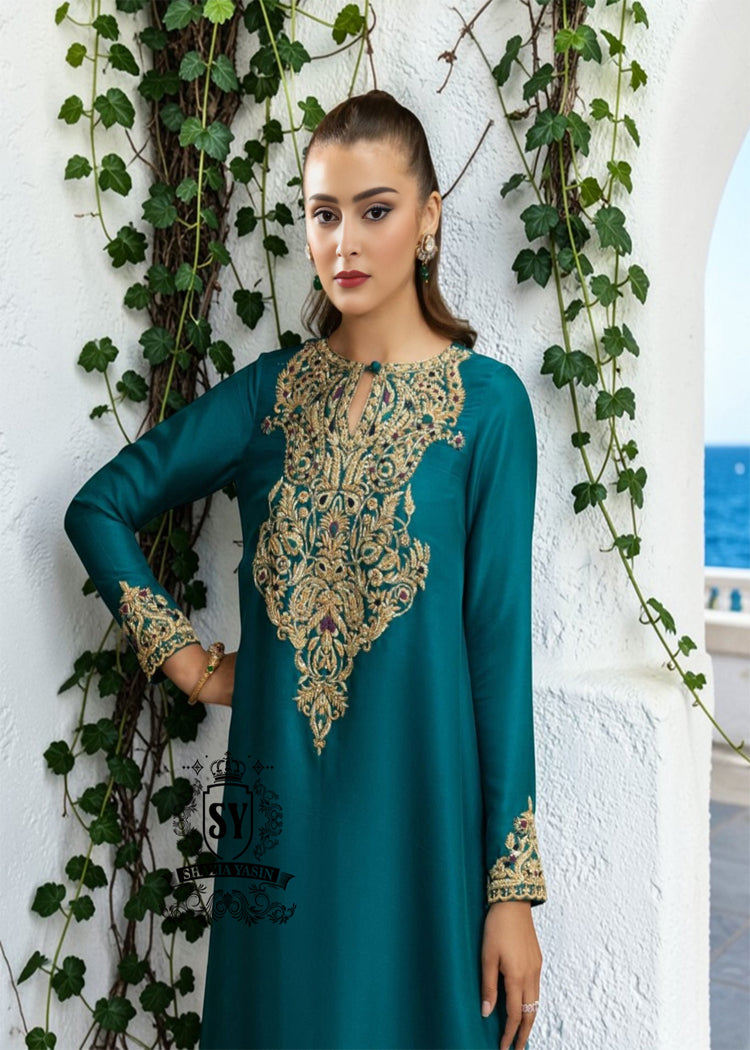 As wedding season blooms, make a sophisticated statement with our exquisite Teal Kaftan dress, crafted from pure raw silk and embellished with intricate dapka, naqshi, and cutdana embroidery. Every detail is carefully designed to highlight your unique radiance and individuality, perfect for any special occasion where you want to be the most spectacular.