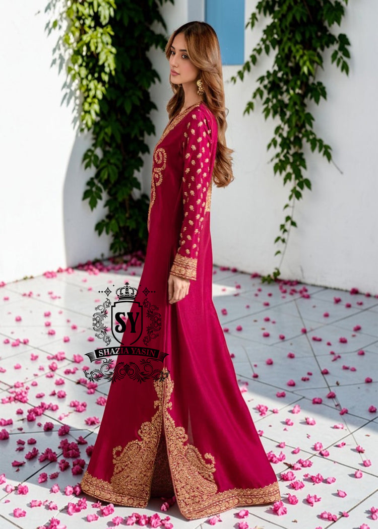 Truly stunning. This Big dip o’ruby raw silk Kaftan is perfect for evening occasions. Delicate Marori embroidery by skilled artisans adorns the sleeves and hem, creating a classic feel. For any celebration this season.