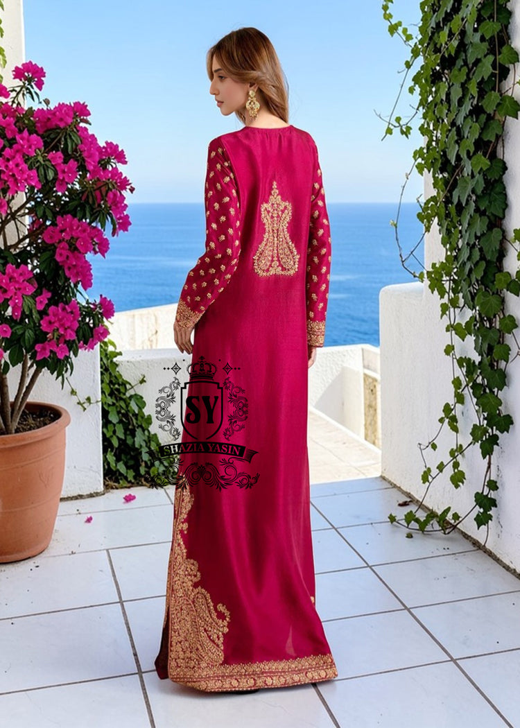Truly stunning. This Big dip o’ruby raw silk Kaftan is perfect for evening occasions. Delicate Marori embroidery by skilled artisans adorns the sleeves and hem, creating a classic feel. For any celebration this season.