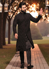 A sophisticated Black classic sherwani, and beautifully executed with intricate hand embroidery featuring sequins and beads. It is designed for versatility.