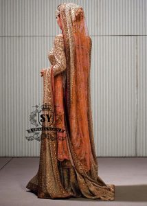 Charming A-line wedding dress with long Fully embellished sleeves and a boat neckline, with a voluminous princess-style lehenga skirt with a spectacular train.