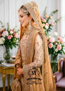 An embellished bridal dress with royal silhouette farshi Lehenga, embodying the perfect blend of classic sophistication and ethereal romance. The Crystal embroidery asserts itself, scattered in places, dense in others, evoking radiant brilliance throughout.