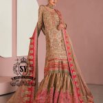 This luxurious, exclusive wedding dress from leading Pakistani designers shimmers with a noble glow in the light. Its majestic Gharara silhouette is perfect for a triumphant entrance, captivating the senses. This look exudes the hand of a true master who understands the value of true beauty.