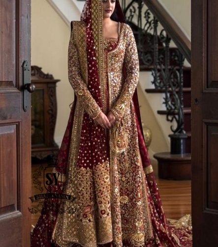 A wedding dress with a long train lehenga embroidered with crystals, created for an unparalleled look for the bride. The delicate embellishments softly sparkles with every movement, while the wedding gown silhouette beautifully highlights her natural elegance.