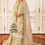 Bride in a wedding dress with floral embellishments and long sheer sleeves, elegant and romantic gharara style.
