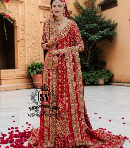 Radiating pure Amaranth Red bridal dress magic with two legged farshi lehenga. A perfect balance of grandeur and simplicity.