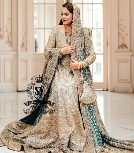A royal look for a Full-figured bride will be created by this A-line long shirt with farshi lehenga dress made of luxurious lame fabric in Tradewind color.