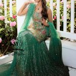 The moment you put on this bridal dress, you will feel like the star of a fairy tale. Rich and yet airy, this look combines a body-con kameez silhouette with a shimmering lehenga skirt.