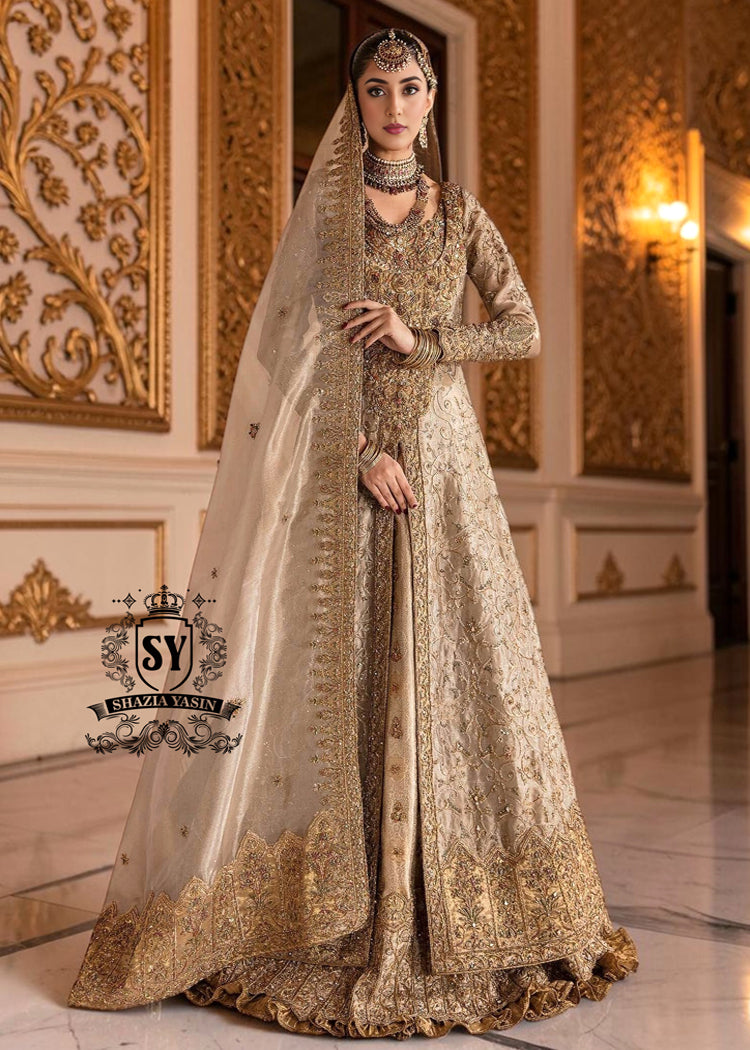 BridalDress245A A Pakistani wedding dress is a captivating sight. Let your dreams become your wings in a wedding dress. This rich Beige gold maxi dress is adorned with carefully placed vibrant motifs, each crafted using tilla, kora Dabka, stones, sequins, beads, silk threads and swarovski crystals, and zardozi techniques.