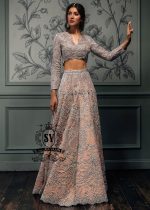 This bespoke bridal Lehenga choli dress is a celebration of romance and craftsmanship — adorned with tens of thousands of hand-sewn crystals that glisten like stardust on layers of ethereal tulle.