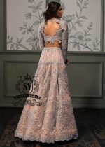 This modern open-back design bespoke bridal Lehenga choli dress is a celebration of romance and craftsmanship — adorned with tens of thousands of hand-sewn crystals that glisten like stardust on layers of ethereal tulle.
