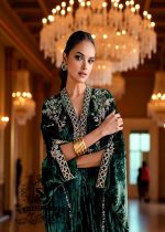 Woman in a green traditional Kaftan outfit with gold jewelry in an elegant indoor setting