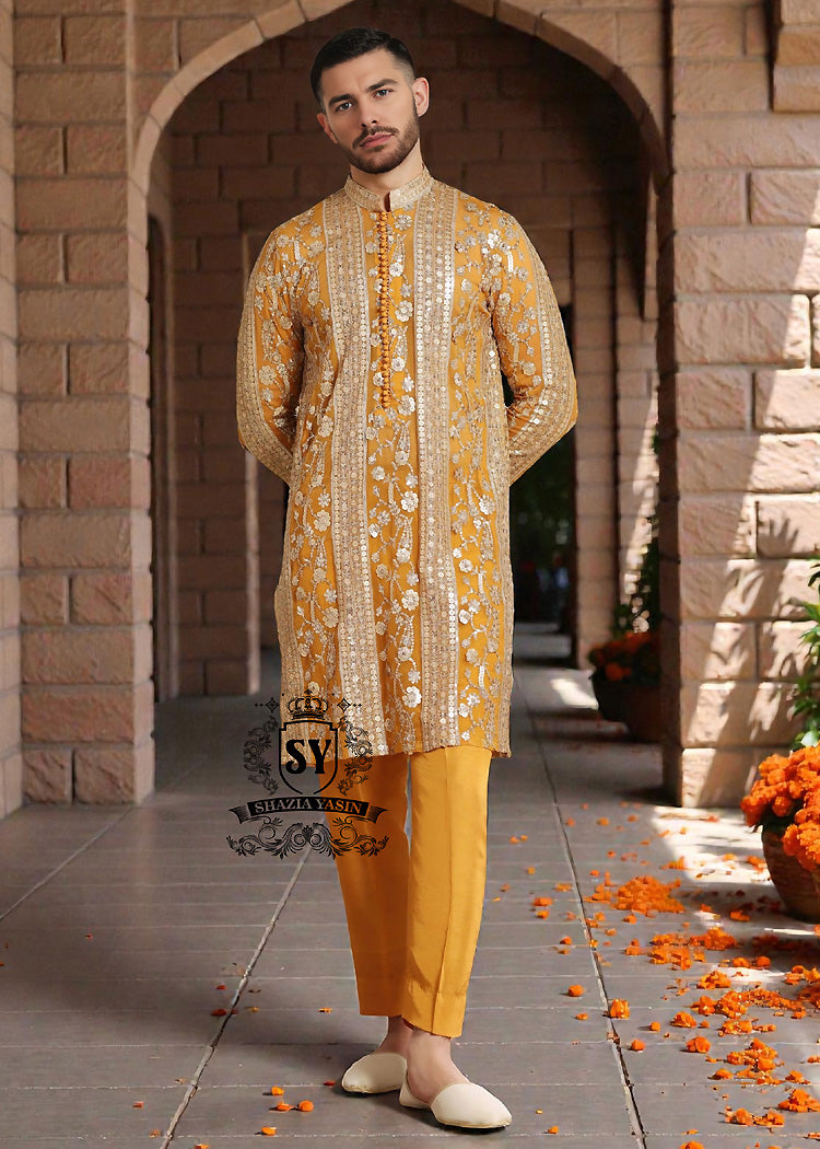 Kurta-Suits-16A A luxurious mustard-gold kurta adorned with delicate floral and geometric embroidery — created for the man who believes in elegance, heritage, and refined festive style.