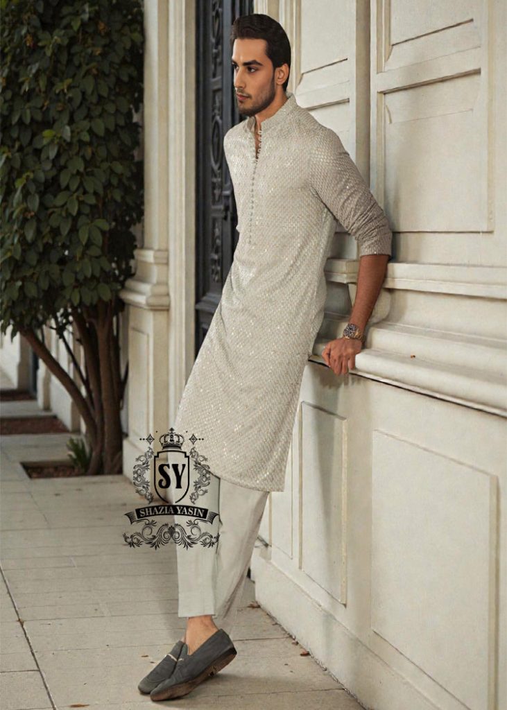 This exquisite kurta embodies sophisticated elegance and timeless grace. Crafted from the finest premium fabrics and meticulously designed with intricate embellishments and delicate sequin work, it exudes understated luxury.