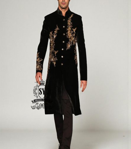 The Rich Black Sherwani jacket with a mandarin collar and jeweled shimmering gold zari embellishments on the front evokes regal elegance, reinterpreted with a modern twist.
