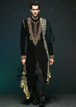 This jet black cocktail velvet form-fitting sherwani is the epitome of elegance. Its impeccable design and luxurious velvet fabric exude a touch of royalty.