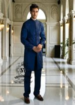 This Admiral Blue sherwani redefines elegance with its intricately executed tone-on-tone adah work, exuding a royal aura with a distinctive modern edge, embodying royal sophistication yet suited to the modern man.