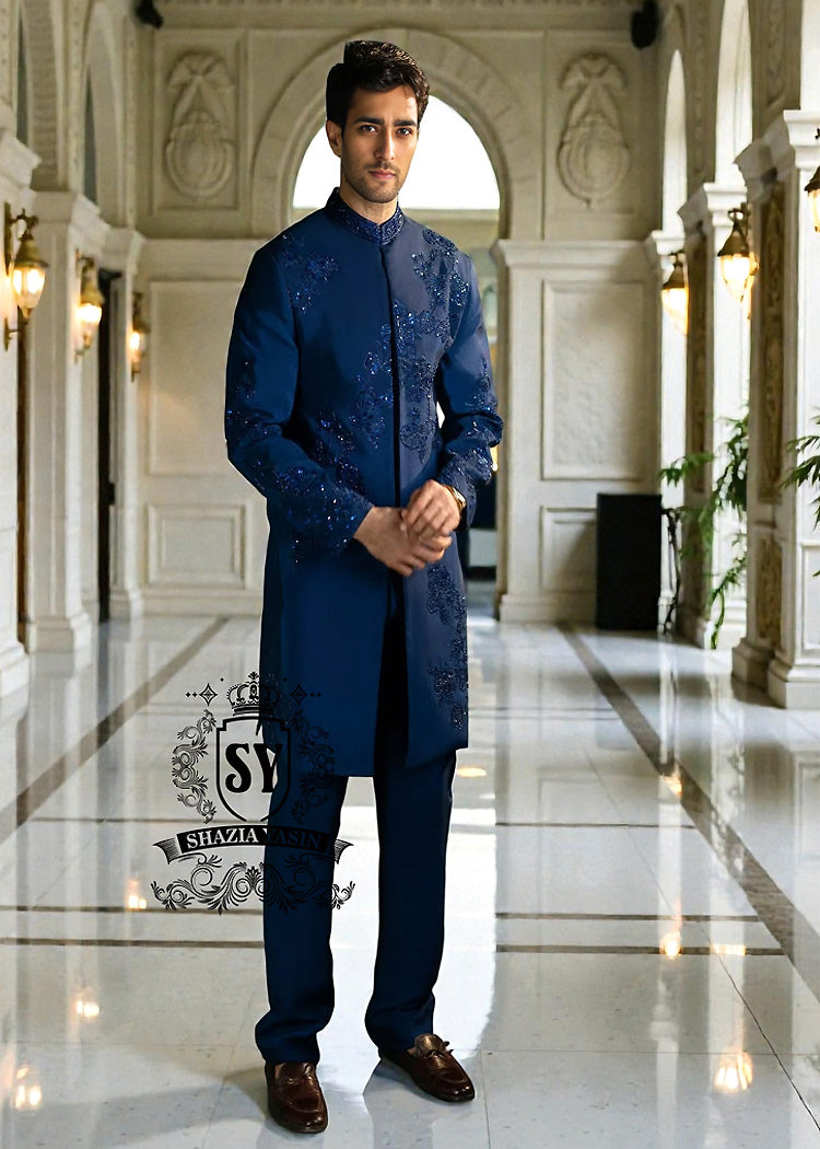 Sherwani200a This Admiral Blue sherwani redefines elegance with its intricately executed tone-on-tone adah work, exuding a royal aura with a distinctive modern edge, embodying royal sophistication yet suited to the modern man.