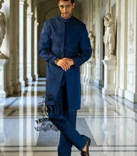 This Admiral Blue sherwani redefines elegance with its intricately executed tone-on-tone adah work, exuding a royal aura with a distinctive modern edge, embodying royal sophistication yet suited to the modern man.