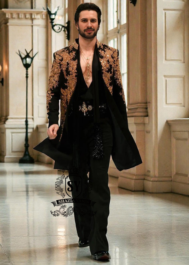 Sherwani201a The intricate golden hand embroidery adds a touch of luxury and sophistication, making this a true Sherwani that will last a lifetime. Effortlessly sleek, perfectly tailored velvet Sherwani in Kokushoku Black— men’s cocktail fits designed for evenings that matter.