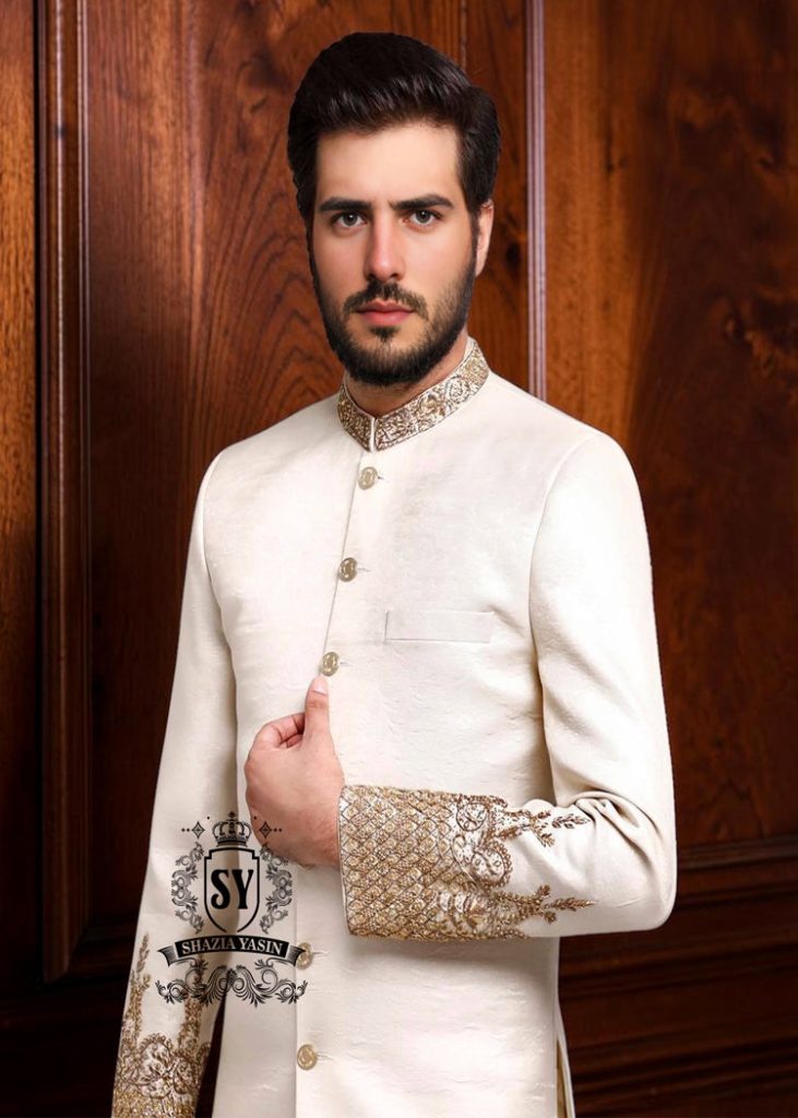 An off-white sherwani design imbued with artistic spirit, every detail meticulously crafted to celebrate the elegant beauty of the groom. The combined with delicate buttons running down the center, creating a focal point that is both classic and modern.