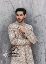 This Sherwani dress will charm everyone with its elegance and exquisiteness. The Blanched Almond color adds a touch of brightness, and beautiful jeweled work border on the front and along the hem creates a feeling of luxury and sophistication.