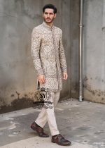 This Sherwani dress will charm everyone with its elegance and exquisiteness. The Blanched Almond color adds a touch of brightness, and beautiful jeweled work border on the front and along the hem creates a feeling of luxury and sophistication.