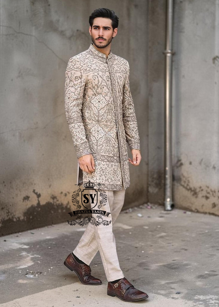 Sherwani207a This Sherwani dress will charm everyone with its elegance and exquisiteness. The Blanched Almond color adds a touch of brightness, and beautiful jeweled work border on the front and along the hem creates a feeling of luxury and sophistication.