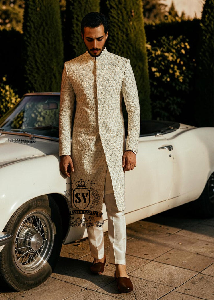 Sherwani208a Pure royalty. A finely hand-embroidered sherwani by Shazia Yasin, elevated with gold accents, paired with a statement mala and a bold crimson turban for a timeless yet striking look.