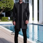 This front-open Sherwani suit boldly expresses a modern style, designed for the man who wants to exude presence without excessive ornamentation. Crafted from high-quality jet-black Korean suit fabric, the exquisite hand embroidery.
