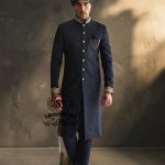 Indulge in a blissful moment with the beautiful Jets Navy Embellished Sherwani For Wedding, crafted from high-quality Jamawaar fabric. Perfect for any wedding occasion, this sherwani will make you shine on your special day.