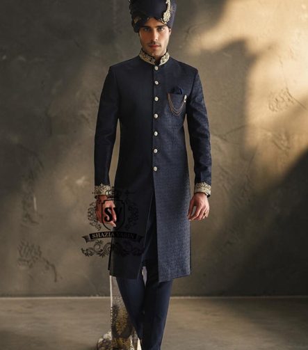 Indulge in a blissful moment with the beautiful Jets Navy Embellished Sherwani For Wedding, crafted from high-quality Jamawaar fabric. Perfect for any wedding occasion, this sherwani will make you shine on your special day.