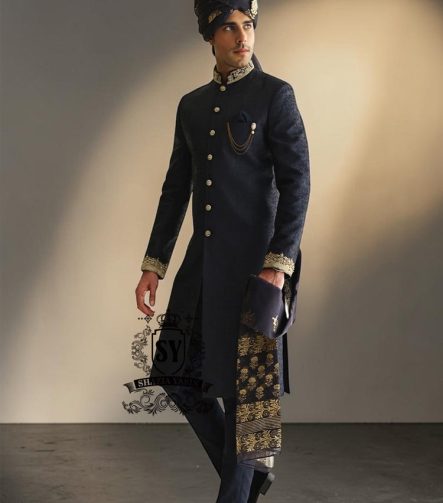 Indulge in a blissful moment with the beautiful Jets Navy Embellished Sherwani For Wedding, crafted from high-quality Jamawaar fabric. Perfect for any wedding occasion, this sherwani will make you shine on your special day.