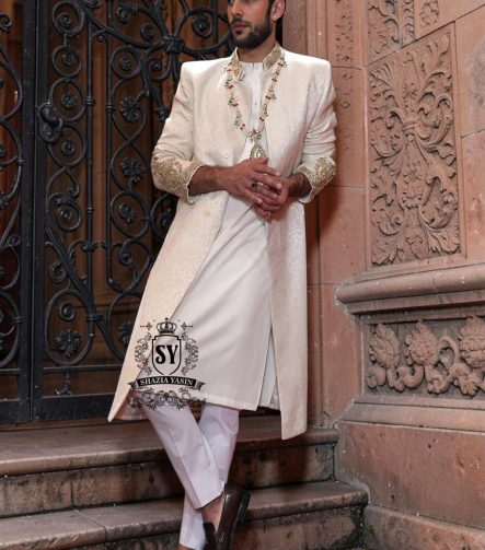 The Luminescence Ivory White Sherwani is a vision of refined romance, crafted in luminous karandi silk that seems to glow with elegance—hand embellishments on the collar and sleeves whispers of heritage artistry,