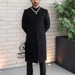 Embrace an aura of graceful distinction with our Elegant Black Sherwani, exquisitely complemented by a matching inner suit, Groom's necklace, and turban. This traditional wedding sherwani captures the very essence of refined elegance, seamlessly intertwining tradition with modern allure.