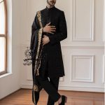 This men's wedding Sherwani is the perfect choice for the groom who wants a refined, modern, and impeccable look on his most important day. The tailored black Sherwani suit elegantly accentuates his figure, while the classic  shawl adds a unique and sophisticated touch.