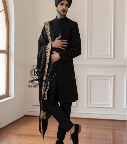 This men's wedding Sherwani is the perfect choice for the groom who wants a refined, modern, and impeccable look on his most important day. The tailored black Sherwani suit elegantly accentuates his figure, while the classic  shawl adds a unique and sophisticated touch.