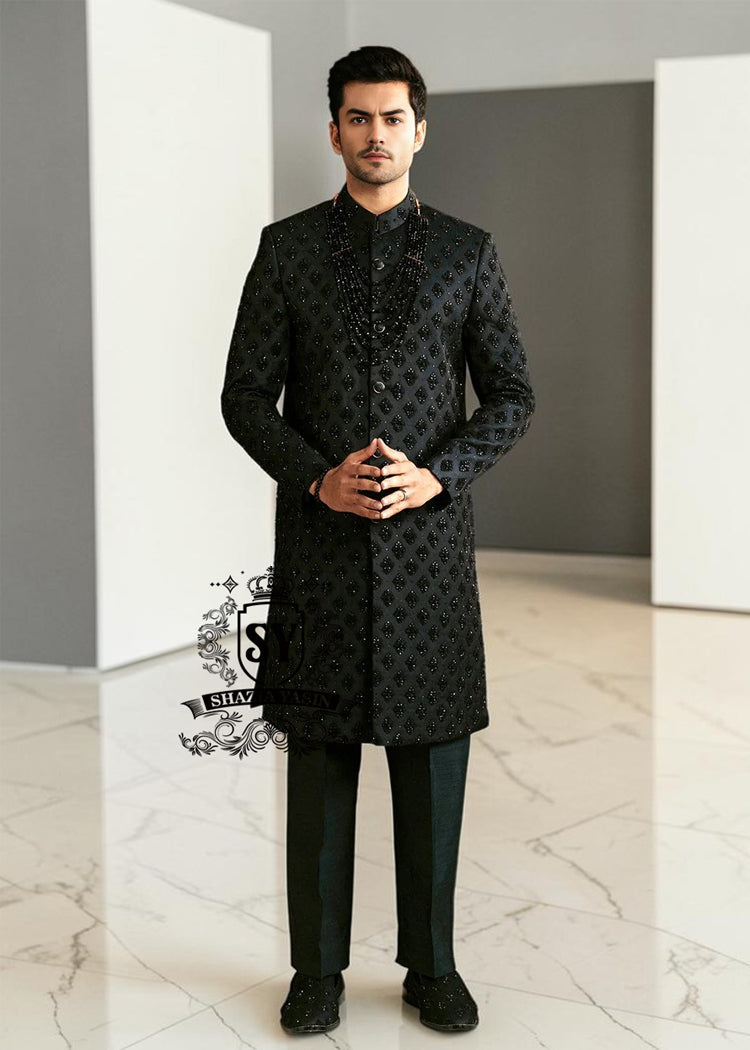 Sherwani224a Black Embroidered Sherwani dignified and sophisticated design, this sherwani in deep black exudes power and elegance. Crafted from premium fabric, intricate embroidery that adds a touch of regal artistry without overpowering its sleek silhouette. The refined tailoring make it an ideal choice for grooms, formal receptions, and grand celebrations.