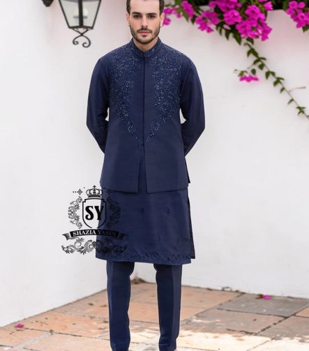 A stylish waistcoat crafted from luxurious navy blue raw silk fabric. The waistcoat itself, the front, and the sleeves are adorned with intricate threadwork and embroidery, giving it a refined and traditional feel.